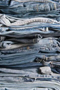 Stack of different old worn blue jeans Stock Photos