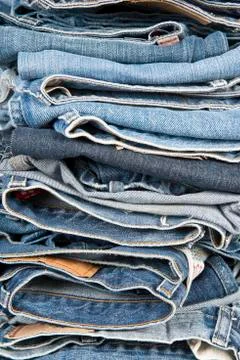 Stack of different old worn blue jeans Foto stock