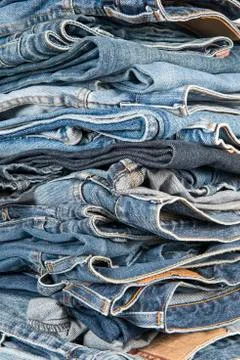 Stack of different old worn blue jeans Stock Photos