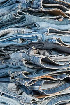 Stack of different old worn blue jeans Stock Photos