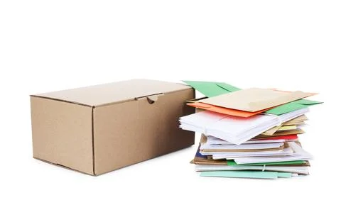 Stack of different paper envelopes and parcel on white background. Post offic Stock Photos