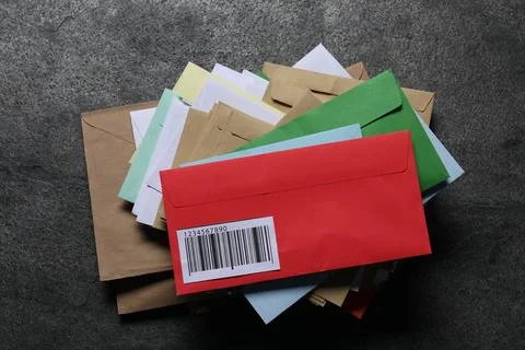 Stack of different paper envelopes on dark grey table, top view. Post office Foto stock