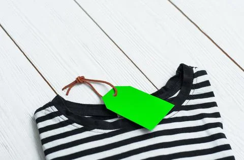 Stack of different polo shirt pants with shopping tag on white color backgrou Foto stock