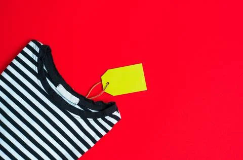 Stack of different polo shirt pants with shopping tag on white color backgrou Stock Photos