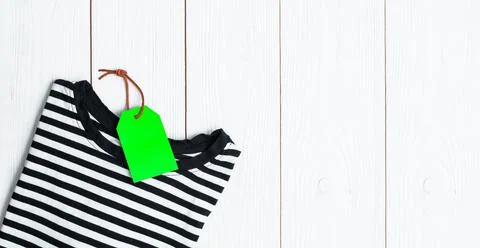 Stack of different polo shirt pants with shopping tag on white color backgrou Stock Photos