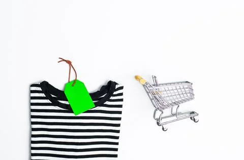 Stack of different polo shirt pants with shopping tag on white color backgrou Stock-Fotos