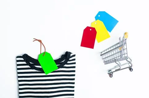 Stack of different polo shirt pants with shopping tag on white color backgrou Foto stock