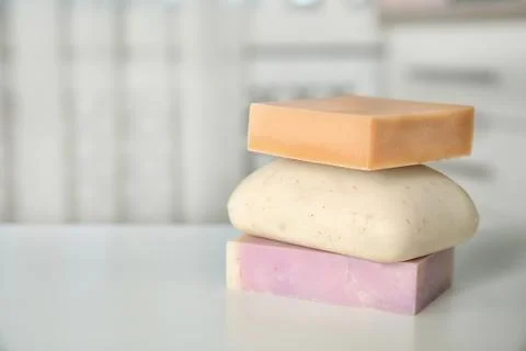 Stack of different soap bars on table. Space for text Foto stock