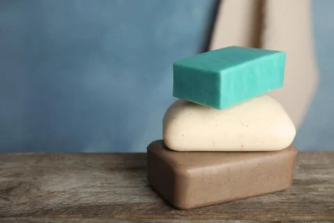 Stack of different soap bars on table. Space for text Foto stock