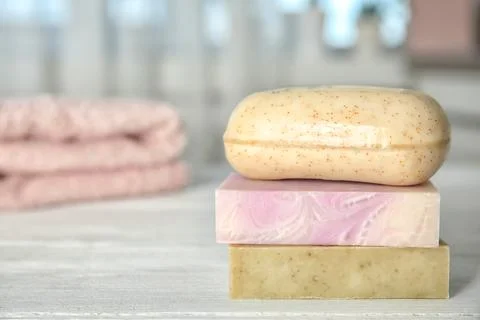 Stack of different soap bars on table. Space for text Foto stock