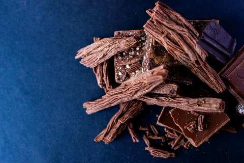 Stack of different types of chocolate pieces on background. Copy sapce Stock-Fotos