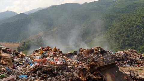 Stack of different types of large garbage dump, plastic bags, and trash burni Stock Footage 117663649