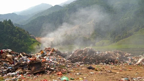 Stack of different types of large garbage dump, plastic bags, and trash burni Stock Footage 117674240