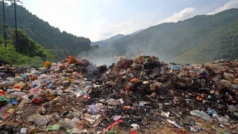 Stack of different types of large garbage dump, plastic bags, and trash burni Video stock 117675454
