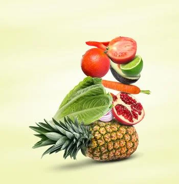 Stack of different vegetables and fruits on pale light yellow background 스톡 사진
