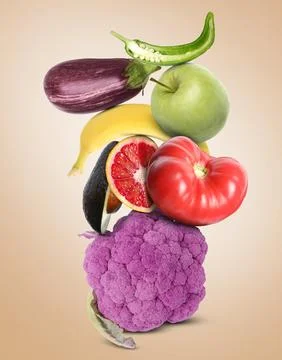 Stack of different vegetables and fruits on beige background Stockfoto's