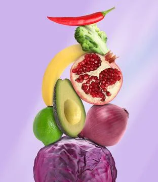 Stack of different vegetables and fruits on pale violet background 스톡 사진