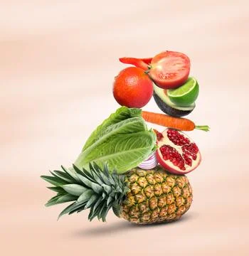 Stack of different vegetables and fruits on beige background Stockfoto's