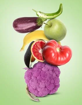 Stack of different vegetables and fruits on pale light green background Stockfoto's