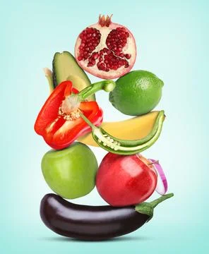 Stack of different vegetables and fruits on light blue background 스톡 사진