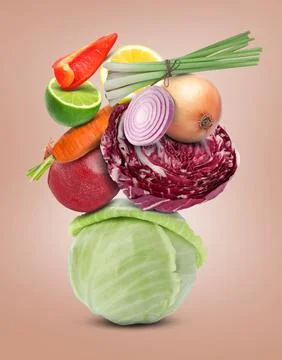 Stack of different vegetables and fruits on pale pink background 스톡 사진