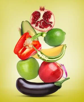 Stack of different vegetables and fruits on yellow background 스톡 사진