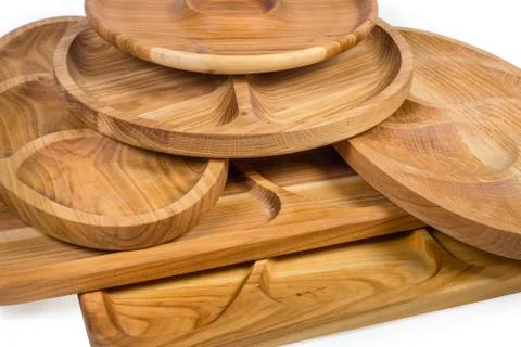 Stack of different wooden compartment dishes and serving boards closeup Stock Photos