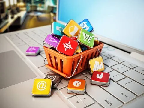 Stack of digital apps inside shopping basket standing on laptop keyboard. ... Foto stock