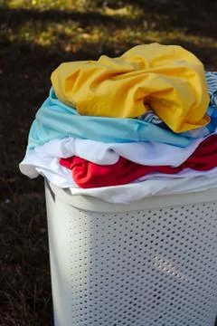 A stack of dirty laundry in a basket Stock Photos