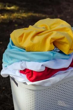A stack of dirty laundry in a basket Stock Photos
