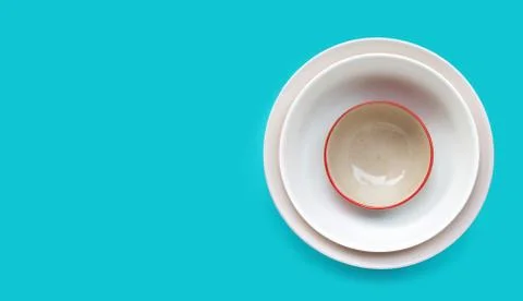Stack of dish and bowl on blue background. Stock Photos