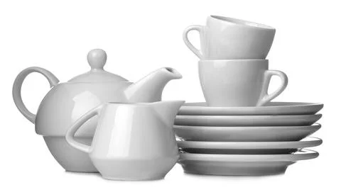 A stack of dishes. Dinnerware. plates, kettle and cup on a white isolated bac Stock Photos