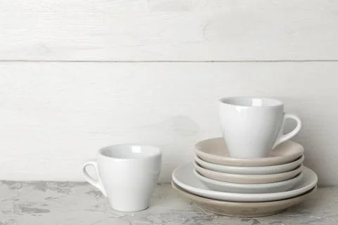 A stack of dishes. tableware on a light concrete background. dishes for servi Stock Photos