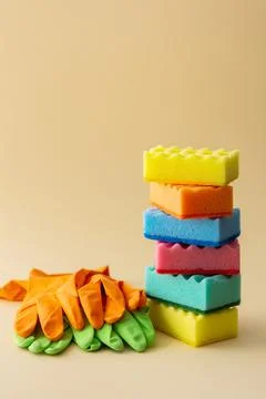 Stack of dishwashing sponges and rubber gloves Stock Photos