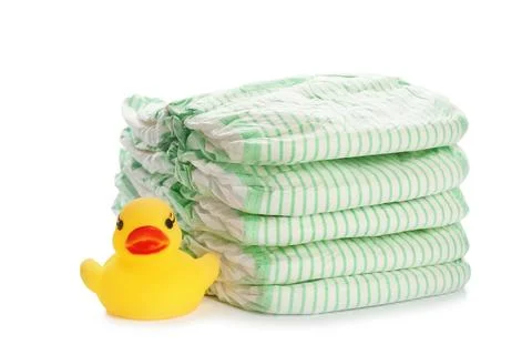 Stack of disposable diapers and toy duck on white background. Baby accessorie Foto stock