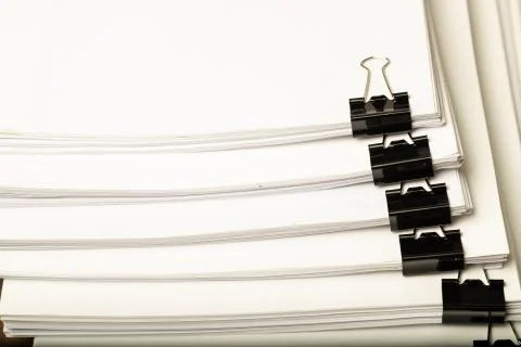 Stack of document paper with black paperclip place Stock Photos
