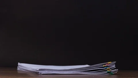 Stack of document paper with colorful paperclip place on wooden table. Stock Footage