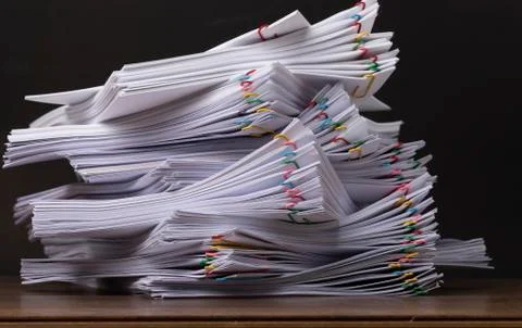 Stack of document paper with colorful paperclip. Stock Photos