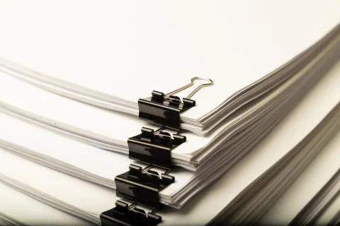 Stack of document paper with colorful paperclip. Stock Photos