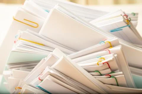 Stack of document paper with colorful paperclip. Stock Photos