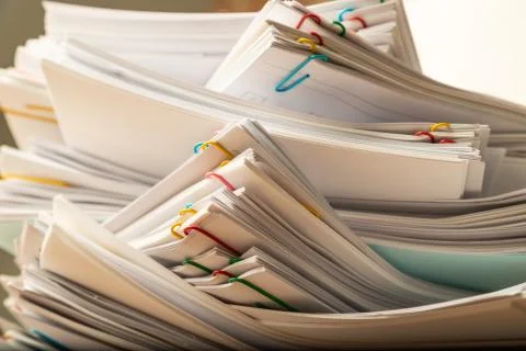 Stack of document paper with colorful paperclip. Stock Photos