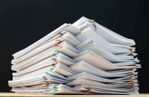 Stack of document paper with colorful paperclip place on wooden table and bla 写真素材
