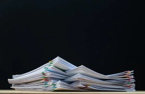 Stack of document paper with colorful paperclip place on wooden table with co Stock Photos