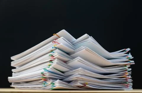 Stack of document paper with colorful paperclip place on wooden table and cop Stock Photos