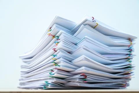 Stack of document paper with colorful paperclip place on wooden table and whi Stock Photos