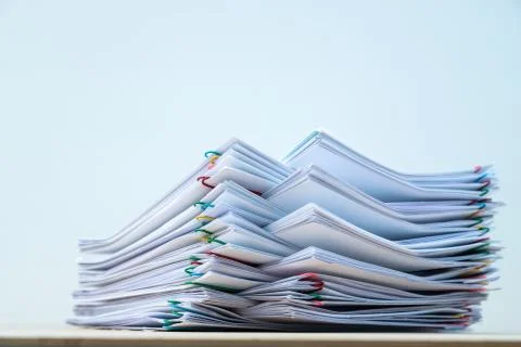 Stack of document paper with colorful paperclip place on wooden table with co Stock Photos