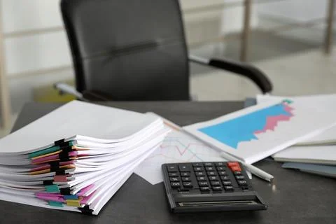 Stack of documents and calculator on office table 스톡 사진