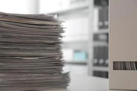Stack of documents and folder with papers on table in office Stock Photos