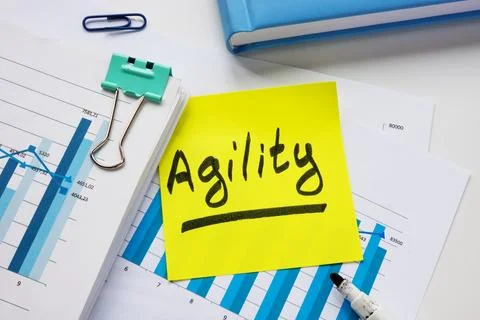 Stack of documents and sticker with inscription agility. Stock Photos