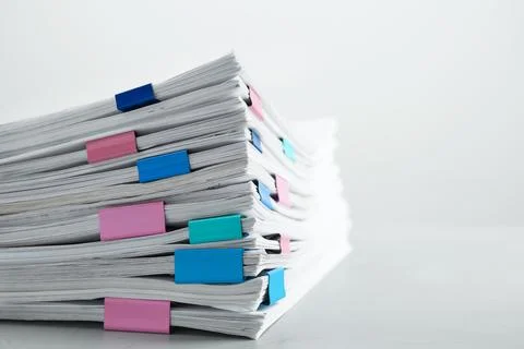 Stack of documents with binder clips on light table, closeup. Space for text Foto stock